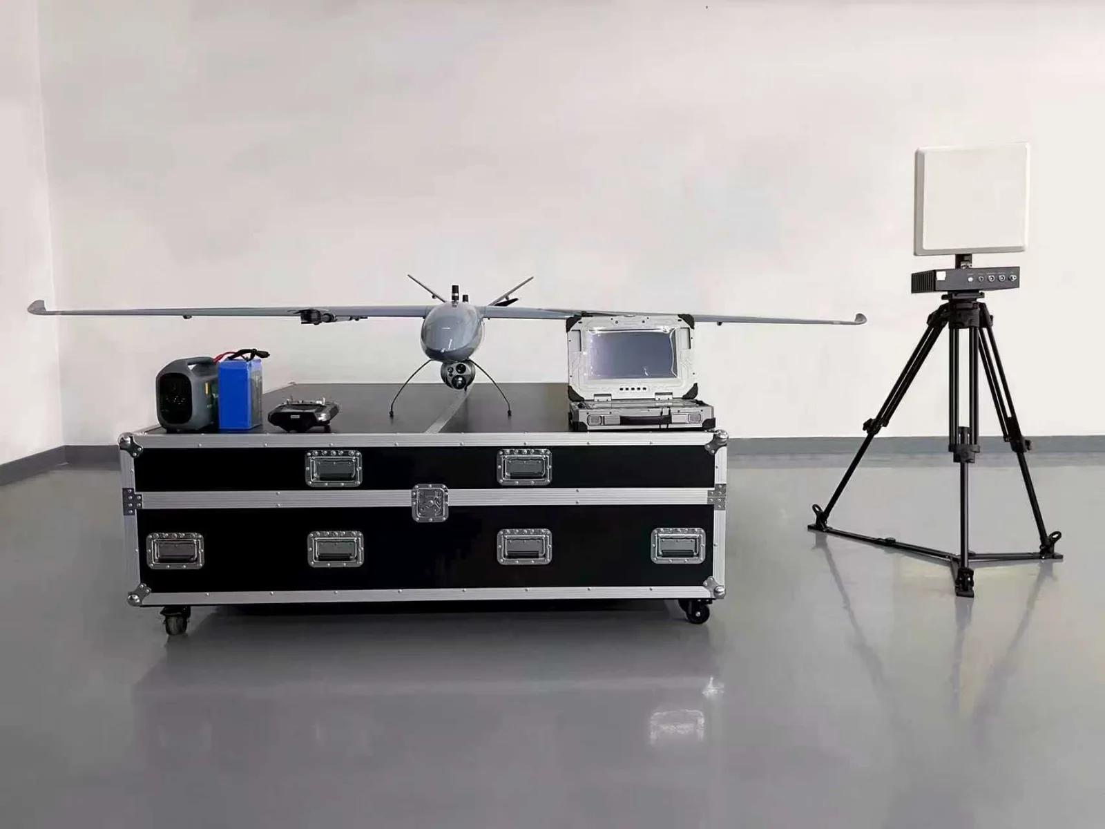Fixed-wing UAV with its gimbal payload and ground control station during a project review