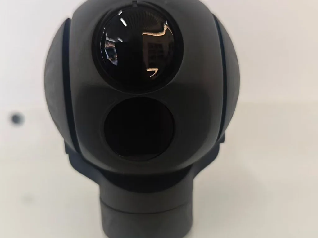 Black spherical gimbal camera payload with daylight and thermal sensor windows