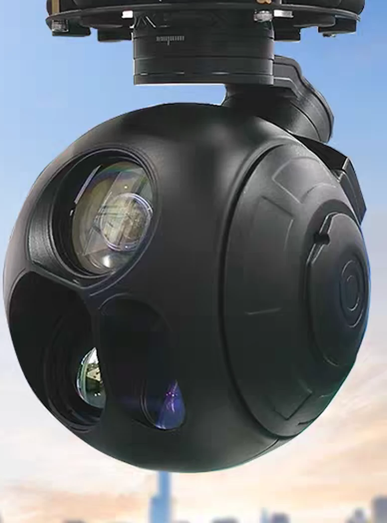 Multi-sensor gimbal camera payload on station against a city skyline