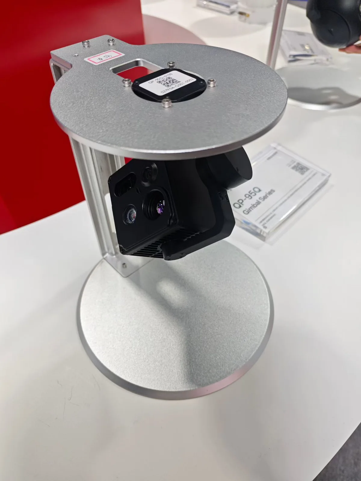 HITS QP-95Q gimbal camera pod on a display stand showing the multi sensor front face