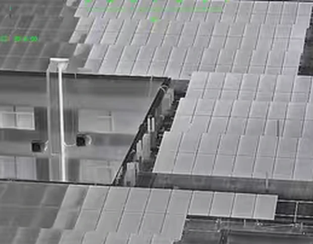 Rooftop solar array seen through the white-hot thermal palette