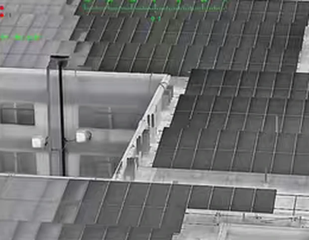 Rooftop solar array seen through the black-hot thermal palette