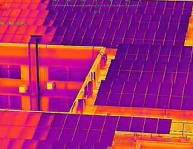 Rooftop solar array seen through the ironbow thermal palette