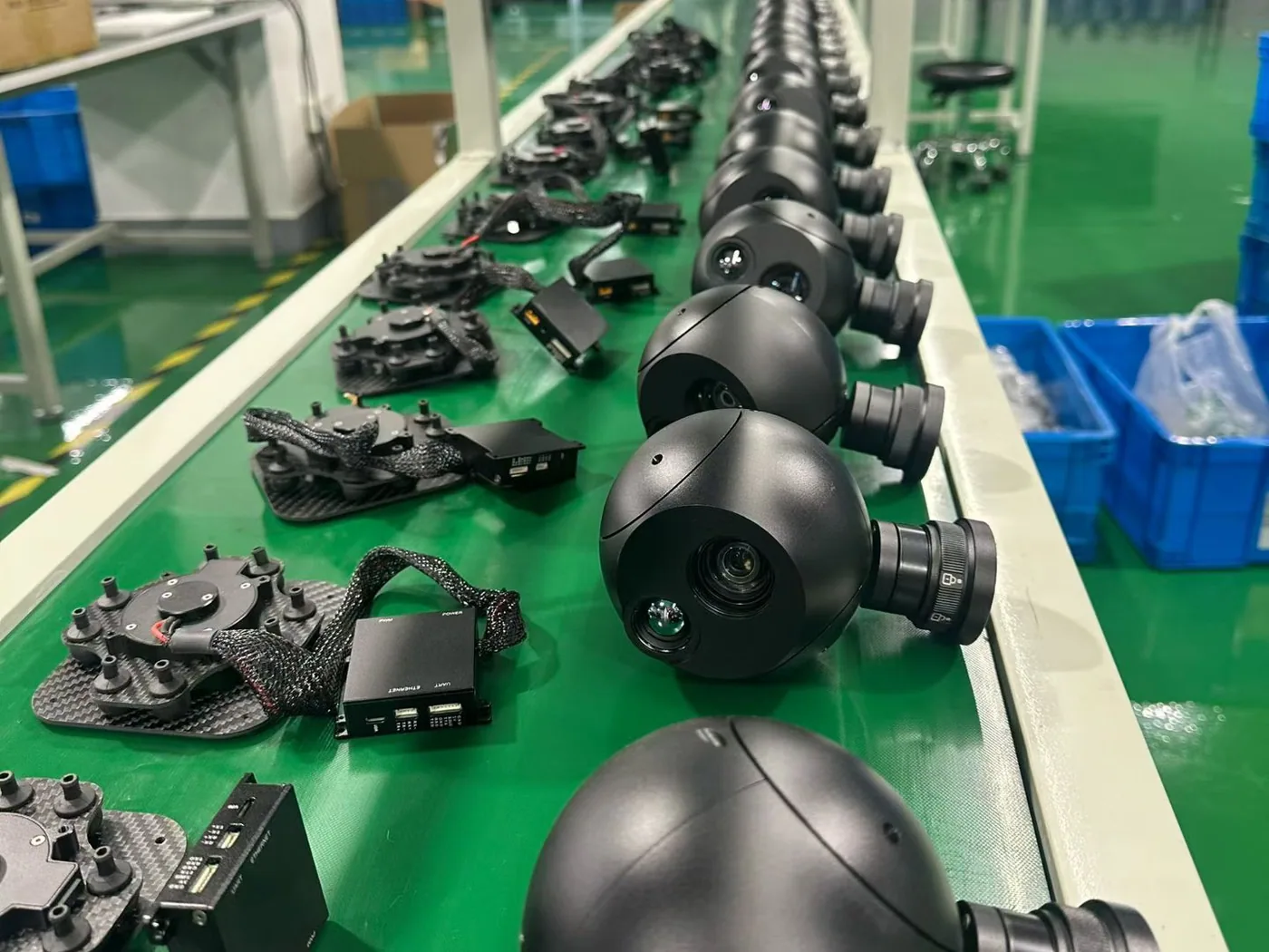 Rows of HITS EO/IR gimbal camera payloads in final assembly on the production line