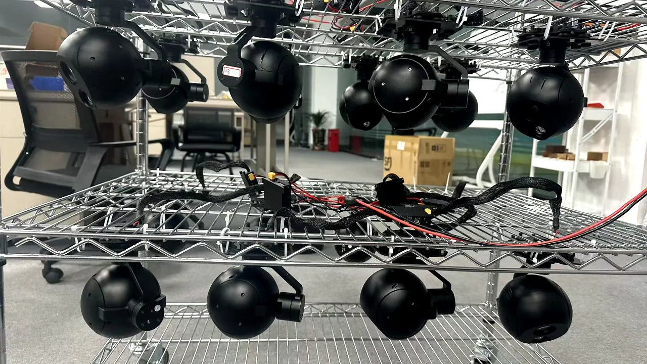 Range of HITS industrial UAV gimbal camera payloads on a production rack, EO and EO/IR heads ready for testing