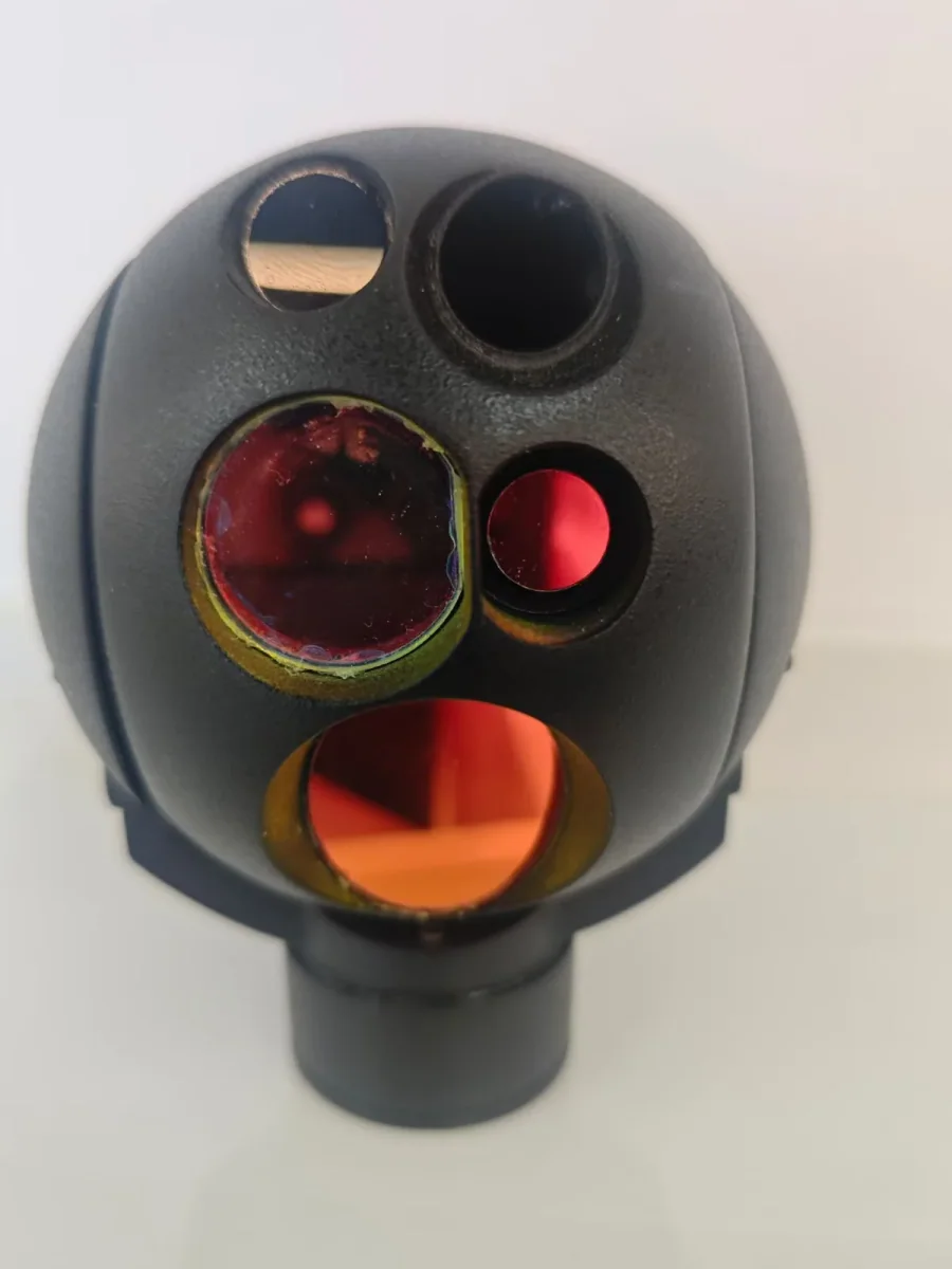 Close detail of the optical apertures on a HITS multi-sensor gimbal camera head