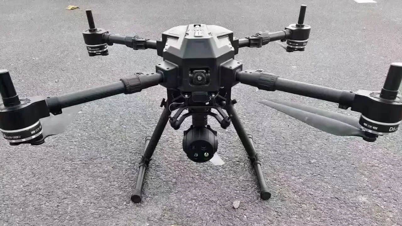 Industrial gimbal camera payload mounted under a heavy-lift multirotor UAV on the ground