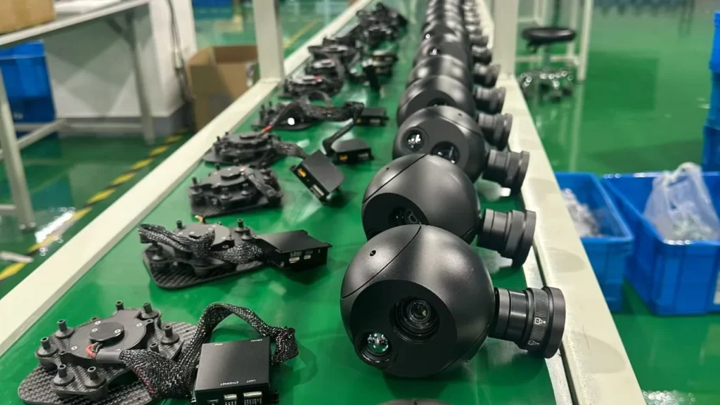 Rows of HITS gimbal camera payloads laid out along a production line before final assembly