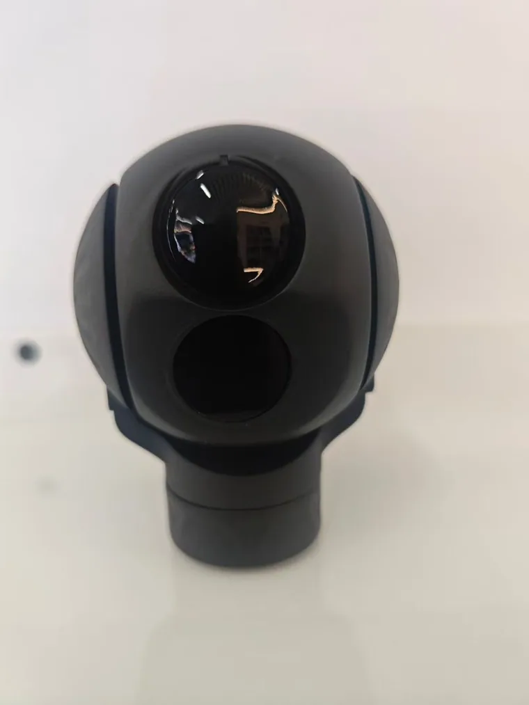 Front view of a HITS gimbal camera head showing its separate electro-optical and thermal sensor apertures