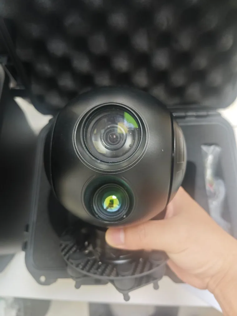 A HITS gimbal camera payload being lifted out of its foam-lined transit case
